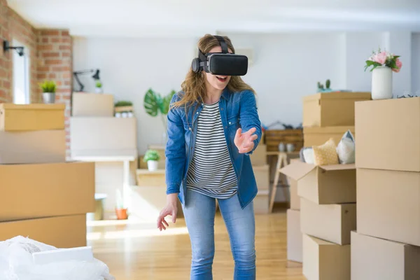 Jovem loira vestindo óculos de realidade virtual jogando um sim — Fotografia de Stock