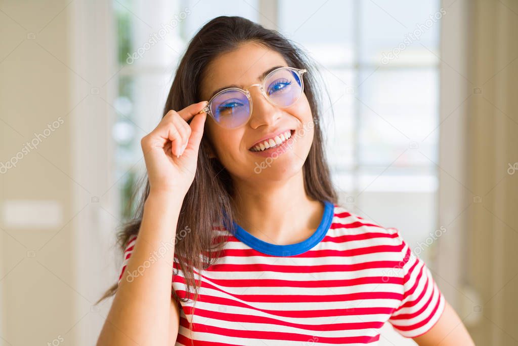 Young beautiful woman smiling cheerful wearing glasses looking happy with a big smile