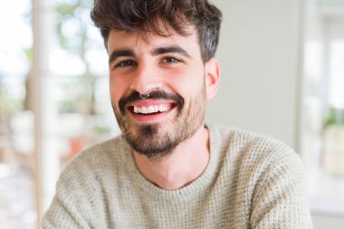 Yakışıklı genç adam büyük bir SMI ile kamera neşeli gülümseyen