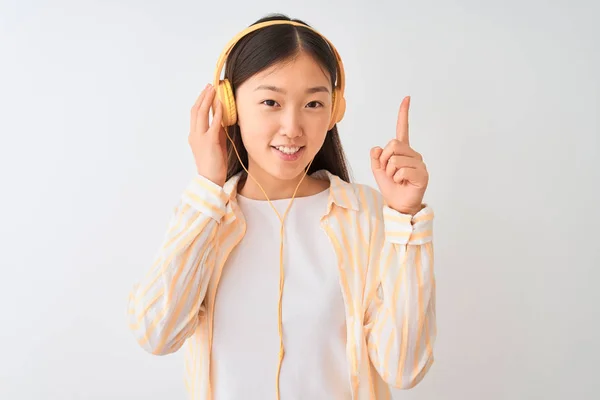 Young Chinese Woman Listening Music Using Headphones Isolated White Background — Stok fotoğraf