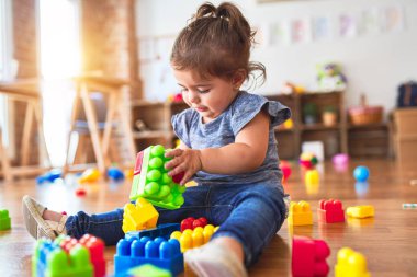 Anaokulundaki oyuncaklarla oynayan güzel bir çocuk.