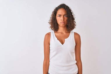 Young brazilian woman wearing casual t-shirt standing over isolated white background skeptic and nervous, frowning upset because of problem. Negative person. clipart
