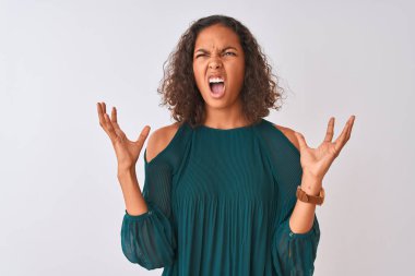 Yeşil tişört giyen genç Brezilyalı kadın izole edilmiş beyaz arka planda duruyor. Deli gibi bağırıyor ve agresif bir ifade ve kollarla bağırıyor. Hayal kırıklığı konsepti.