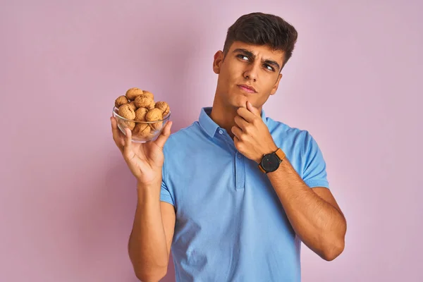 Young Indian Man Holding Bowl Walnuts Standing Isolated Pink Background — Stock Photo, Image