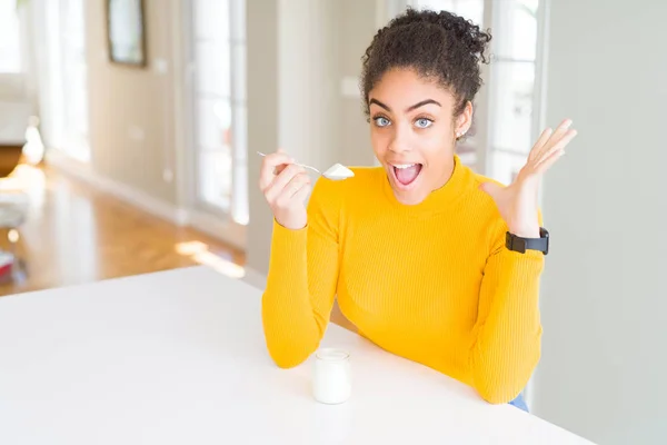 Young African American Woman Eating Healthy Natural Yogurt Very Happy — Stock Photo, Image