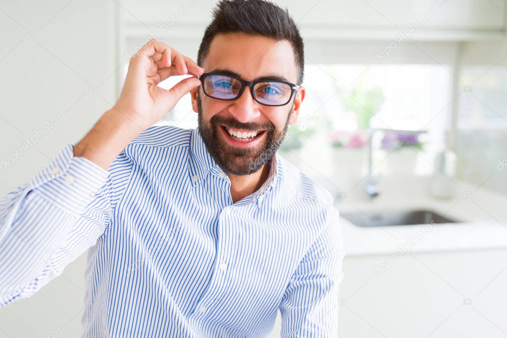 Handsome business man wearing glasses and smiling cheerful with 