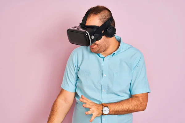 Young plus size man playing virtual reality game using goggles