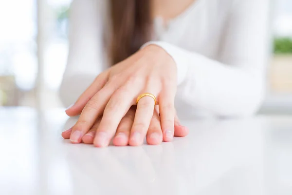 Close up of woman hands wearing wedding alliance ring over white — Stock Photo, Image