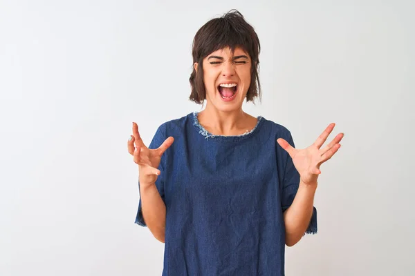 stock image Young beautiful woman wearing denim dress standing over isolated white background celebrating mad and crazy for success with arms raised and closed eyes screaming excited. Winner concept