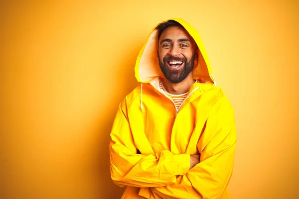 Young Indian Man Wearing Raincoat Hood Standing Isolated Yellow Background — 스톡 사진