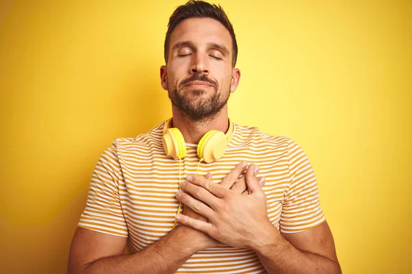 Young Handsome Man Wearing Headphones Listening Music Yellow Isolated Background — Stock Photo, Image