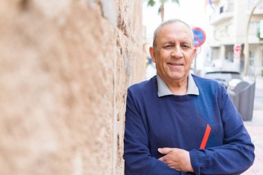 Yakışıklı orta yaş kıdemli neşeli, mutlu gülümseyen adam ve yerine koymak