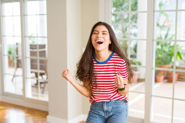 Beautiful young woman celebrating excited for success, screaming and smiling for winning