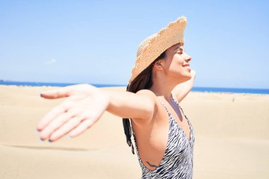 Güneş banyosu yapan genç ve güzel bir kadın. Maspalomas Kumulları 'nda yaz eşofmanı giyiyor.
