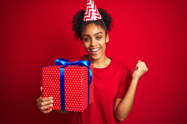 Afro Amerikaanse Vrouw Draagt Grappige Hoed Houden Verjaardagscadeau Geïsoleerde Rode — Stockfoto