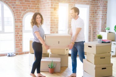 Orta yaş Senior çift yeni bir eve hareket, cardboar tutarak