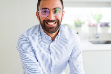 Gözlük takan ve yüz kendine güvenen gülümseme ile neşeli gülümseyen yakışıklı iş adam