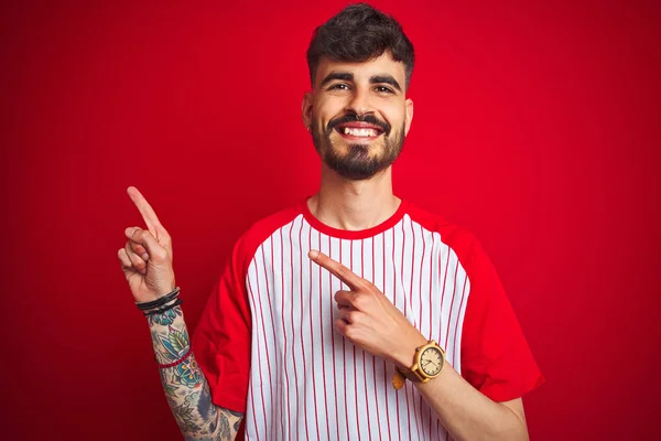 Jovem Com Tatuagem Vestindo Camiseta Listrada Sobre Fundo Vermelho Isolado — Fotografia de Stock
