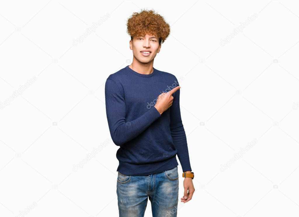 Young handsome man with afro hair Pointing with hand finger to the side showing advertisement, serious and calm face