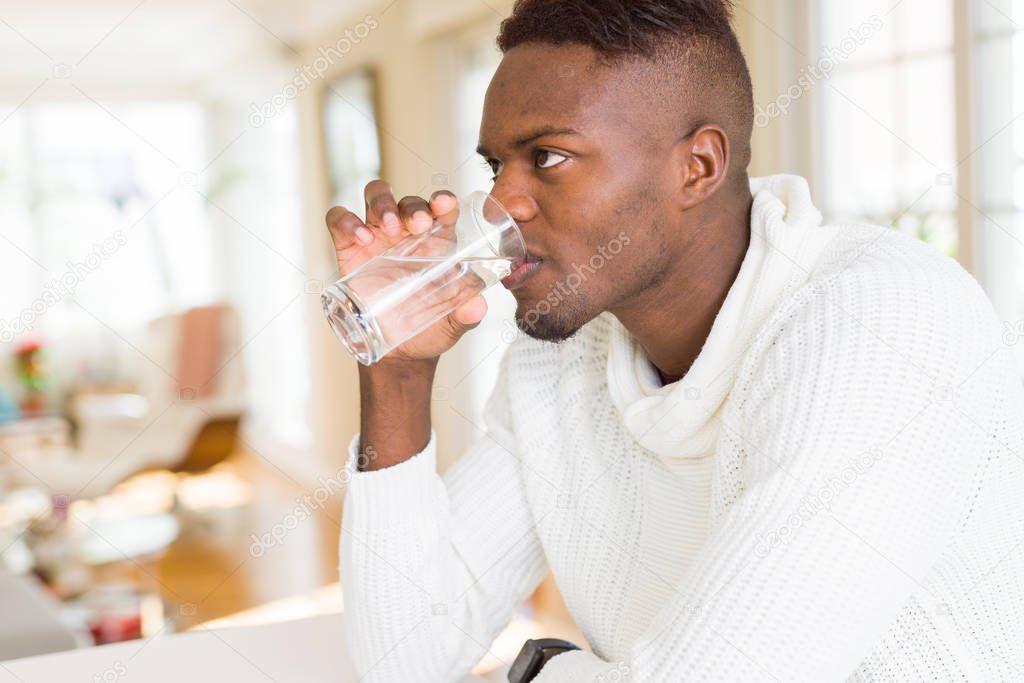 Young african american man drinking a fresh glass of water