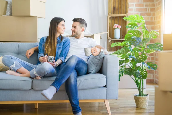 Young Couple Moving New Home Relaxing Sitting Sofa While Drinking — Stock Photo, Image