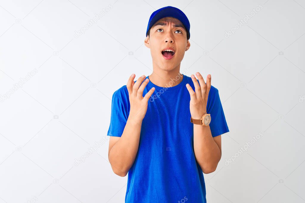 Chinese Deliveryman Wearing Blue T Shirt And Cap Standing Over Isolated White Background Crazy And Mad Shouting And Yelling With Aggressive Expression And Arms Raised Frustration Concept Larastock Chinese Deliveryman Wearing Blue T Shirt And Cap Standing Over Isolated White Background Crazy And Mad Shouting And Yelling With Aggressive Expression And Arms Raised Frustration Concept Larastock