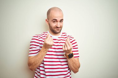 Sakallı, beyaz tenli, sıradan kırmızı tişörtlü genç, kel bir adam. Elleriyle para hareketi yapıyor. Maaş ödemesi istiyor.