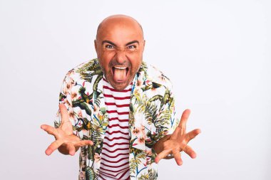 Tatildeki orta yaşlı yakışıklı bir adam izole edilmiş beyaz arka plan üzerinde tişört giyiyor çılgın ve başarıyı kollarını kaldırıp heyecanla haykırarak kutluyor. Kazanan konsept