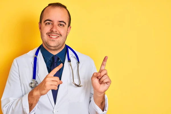 Young Doctor Man Wearing Coat Stethoscope Standing Isolated Yellow Background — Stock Photo, Image