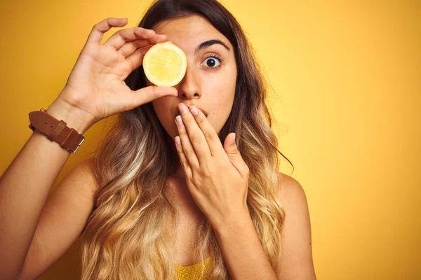 Jovem Bela Mulher Segurando Limão Olho Sobre Amarelo Isolado Fundo — Fotografia de Stock