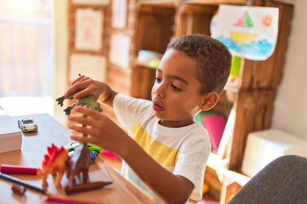 Beautiful African American Toddler Playing Dinosaurs Toy Desk Kindergarten — ストック写真