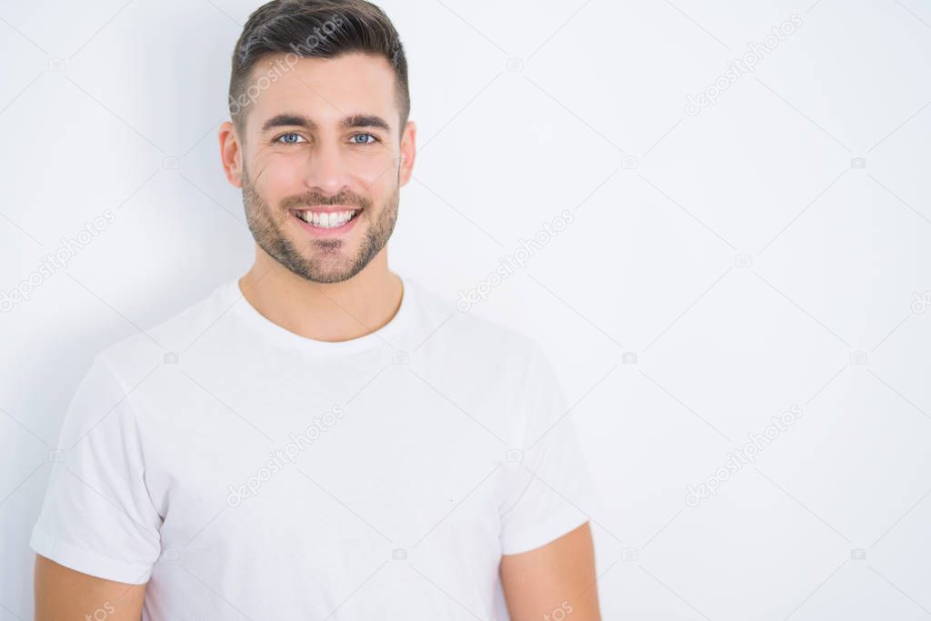 Young handsome man smiling happy wearing casual white t-shirt over white isolated background