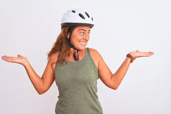 中年骑自行车的女性 头戴安全帽 背对着孤立的背景 微笑着张开双手 展示和宣传比较与平衡 — 图库照片