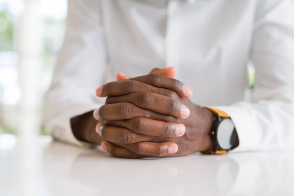 Close Van Gekruiste Handen Van Afrikaanse Man Tafel — Stockfoto