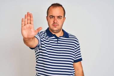 Sıradan çizgili polo giyen genç adam izole edilmiş beyaz arka planda durup avucunun içi gibi şarkı söylemeyi kesiyor. Yüzünde olumsuz ve ciddi bir jest olan uyarı ifadesi.