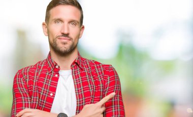 Rahat gömlek giyen yakışıklı adam reklam, ciddi ve sakin yüz gösteren yan el parmağı ile Işaret