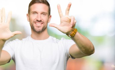 Casual beyaz t-shirt gösterme ve parmakları ile işaret giyen yakışıklı adam kendinden emin ve mutlu gülümseyerek süre sekiz numara.