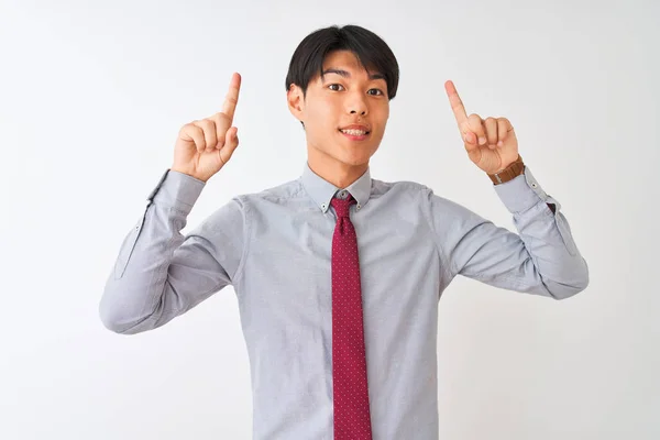 中国のビジネスマンは 孤立した白い背景の上に立ってエレガントなネクタイを身に着けている笑顔と驚きと指と腕を上げて指摘 — ストック写真
