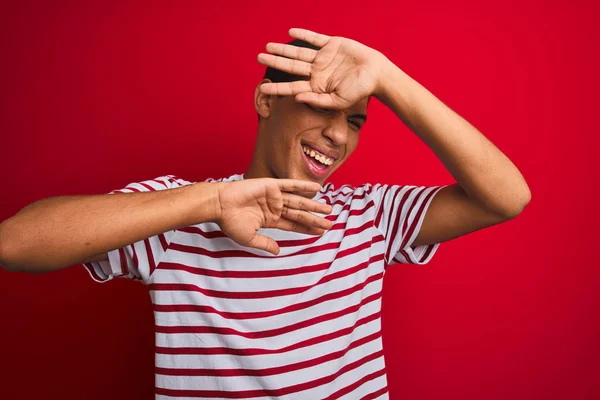 Jonge Knappe Arabische Man Dragen Gestreepte Shirt Geïsoleerde Rode Achtergrond — Stockfoto