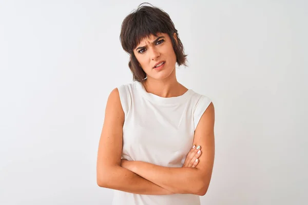 Young beautiful woman wearing casual t-shirt standing over isolated white background skeptic and nervous, disapproving expression on face with crossed arms. Negative person.