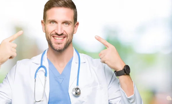 Handsome Doctor Man Wearing Medical Uniform Isolated Background Smiling Pointing — Stock Photo, Image