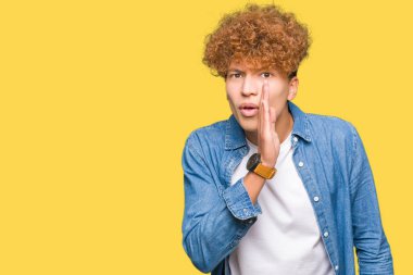 Afro saçlı genç yakışıklı adam ağzına kot ceket el giyen gizli söylenti söylüyorum, kötü niyetli konuşma konuşma fısıldıyor