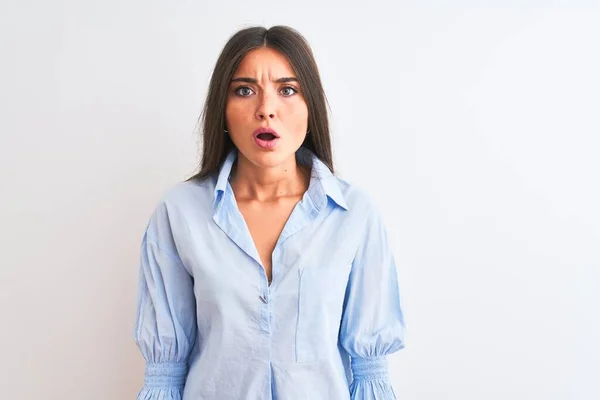 stock image Young beautiful woman wearing blue elegant shirt standing over isolated white background afraid and shocked with surprise expression, fear and excited face.