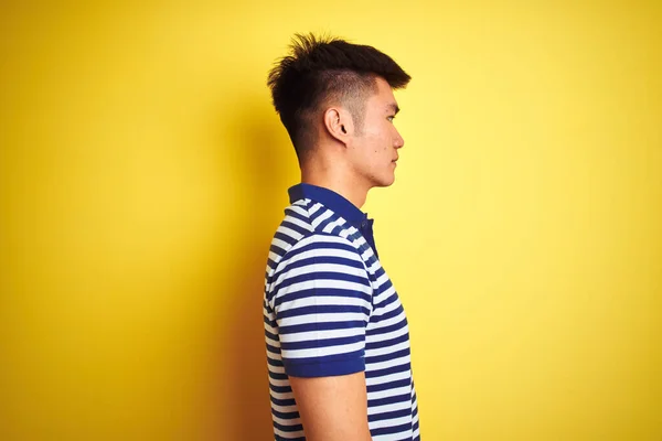 Young Asian Chinese Man Wearing Striped Polo Standing Isolated Yellow — ストック写真