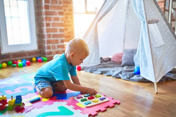 Young caucasian kid playing at kindergarten with toys. Preschool — Stock Photo, Image