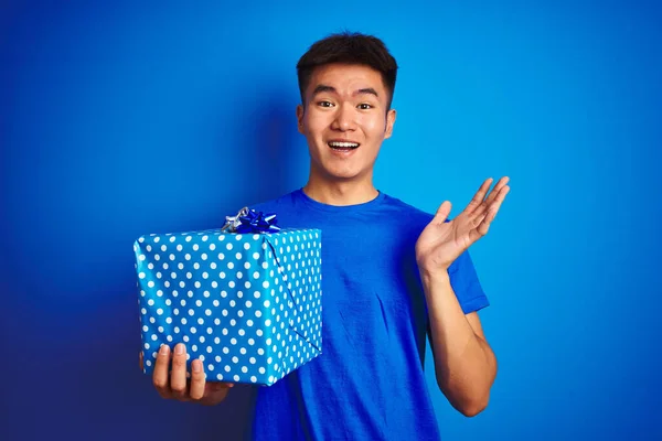 Young Asian Chinese Man Holding Birthday Gift Standing Isolated Blue — ストック写真
