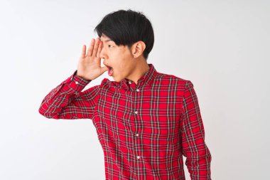 Gündelik kırmızı gömlekli genç Çinli adam izole edilmiş beyaz arka planda durup el ele tutuşarak bağırıyor ve bağırıyordu. İletişim konsepti.