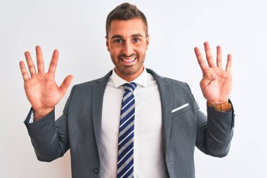 Takım elbiseli ve kravatlı genç yakışıklı iş adamı dokuz numaralı parmaklarıyla kendini beğenmiş ve mutlu gülümserken kendini gösteriyor..