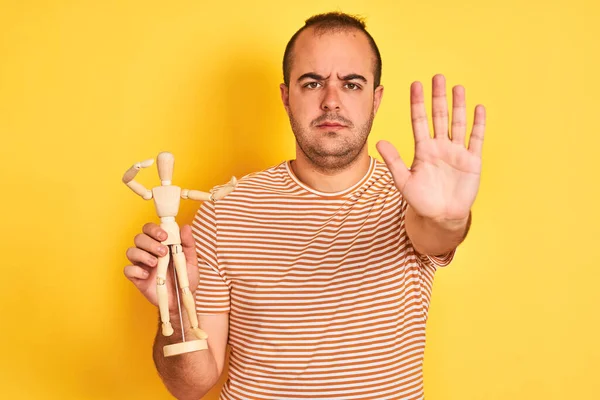 Young Man Holding Figure Art Dummy Standing Isolated Yellow Background — Stock Photo, Image