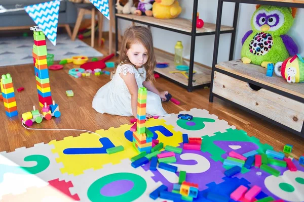 Adorable Blonde Toddler Playing Building Blocks Lots Toys Kindergarten — ストック写真